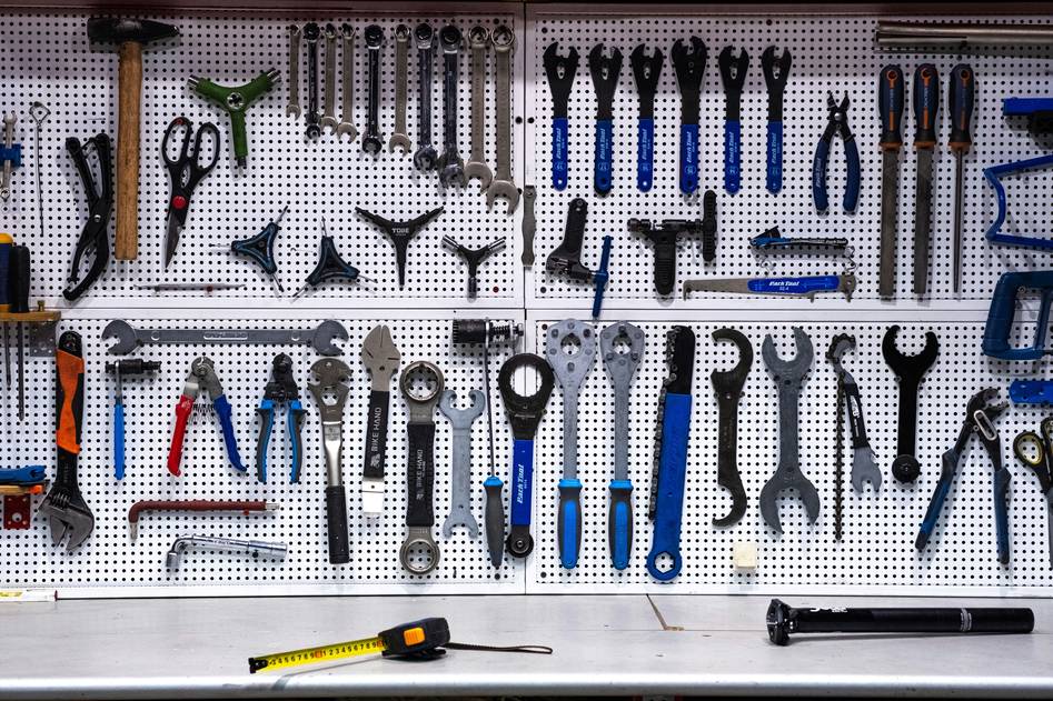 Assorted wrenches and hardware tools on workbench